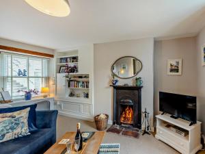 a living room with a blue couch and a fireplace at 1 Bed in Brixham oc-bx036 in Brixham