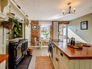 a kitchen with a stove and a counter top at 1 Bed in Brixham oc-bx036 in Brixham