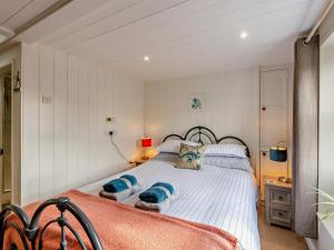 a bedroom with a large white bed with blue pillows at 1 Bed in Brixham oc-bx036 in Brixham