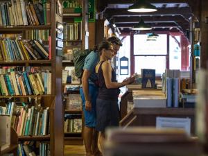 two people standing in a library looking at a book at 3 Bed in Hay-on-wye oc-bn070 in Hay-on-Wye