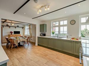 a kitchen and dining room with a table and a dining room at 3 Bed in Bideford oc-bybur in Bideford