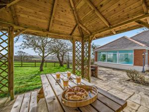 a wooden table with a plate of food on it at 3 Bed in Bideford oc-bybur in Bideford