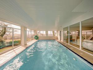 a large swimming pool in a house with windows at 3 Bed in Bideford oc-bybur in Bideford