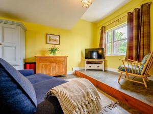 a living room with a blue couch and a tv at 2 Bed in Egremont oc-87227 in Egremont