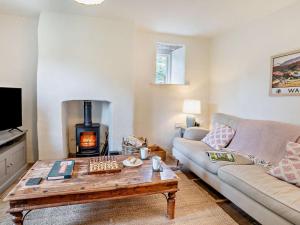 a living room with a couch and a fireplace at 2 Bed in Chepstow oc-42837 in Wolves Newton