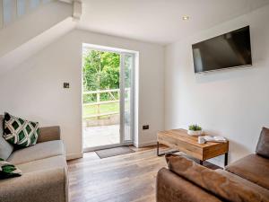 a living room with a couch and a table at 1 Bed in Pontypool oc-83405 in Mamhilad