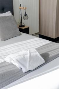 a bed with two white towels sitting on it at SLO HOSTEL Bordeaux in Bordeaux