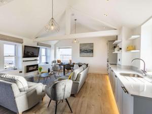 a kitchen and living room with a couch and chairs at 4 Bed in Bideford oc-86776 in Appledore +17 photos