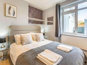 a bedroom with a bed with two towels on it at 4 Bed in Bideford oc-86776 in Appledore