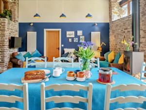 a blue dining room with a table with a cake on it at 4 Bed in Brecon oc-bn182 in Talgarth +39 photos