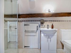 a white bathroom with a sink and a shower at 4 Bed in Brecon oc-bn182 in Talgarth