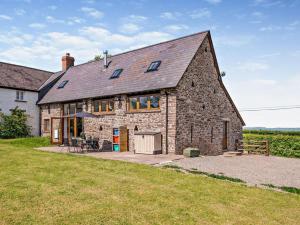 an old stone house with a patio in a field at 4 Bed in Brecon oc-bn182 in Talgarth