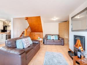 a living room with a couch and a fireplace at 4 Bed in Llandovery oc-82440 in Llanfair-ar-y-bryn
