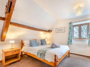a bedroom with two beds and a window at 4 Bed in Llandovery oc-82440 in Llanfair-ar-y-bryn
