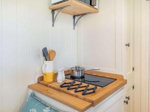 a kitchen counter with a stove with a pot on it at 1 Bed in Stockport oc-87592 in Mellor +22 photos