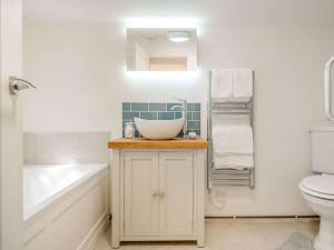 a bathroom with a sink and a tub and a toilet at 1 Bed in Brecon oc-88748 in Aber-Brân +25 photos