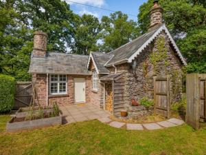 a stone house with a garden in front of it at 1 Bed in Brecon oc-88748 in Aber-Brân