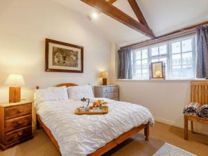 a bedroom with a bed with a tray of fruit on it at 3 Bed in Abergavenny oc-90233 in Llanvetherine +20 photos