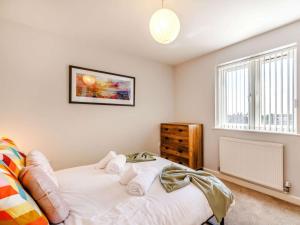 a bedroom with a white bed and a window at 5 Bed in Matlock oc-88486 in Crich