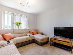 a living room with a couch and a flat screen tv at 5 Bed in Matlock oc-88486 in Crich