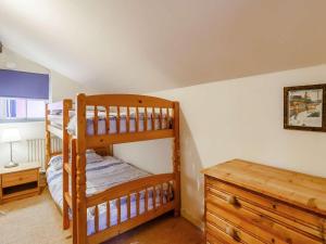 a bedroom with two bunk beds and a desk at 2 Bed in Abergavenny oc-90235 in Llanvetherine