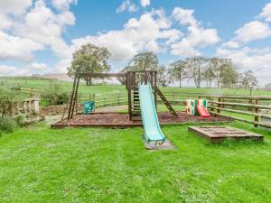 a playground in a field with a slide at 2 Bed in Abergavenny oc-90235 in Llanvetherine