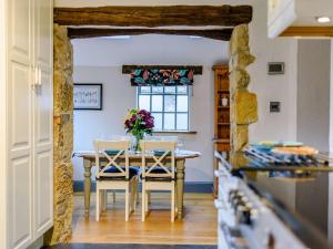 a dining room with a table and chairs and a window at 2 Bed in Bakewell oc-91038 in Bakewell