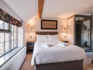 a bedroom with a large bed with white sheets at 2 Bed in Bakewell oc-91038 in Bakewell