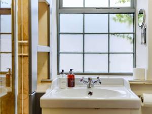 a sink in a bathroom with a window and a window at 2 Bed in Bakewell oc-91038 in Bakewell +14 photos
