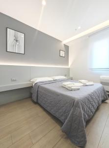 a bedroom with a bed with two towels on it at The Superhost - IL Lux in Crotone +24 photos