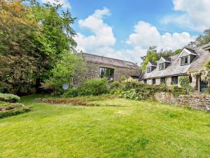 an old stone house with a grass yard at 3 Bed in Llandovery oc-bn093 in Llandovery