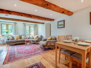 a living room with a table and chairs at 2 Bed in Chepstow oc-95046 in Chepstow