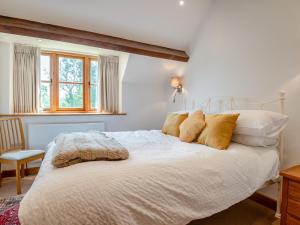 a bedroom with a large white bed with yellow pillows at 2 Bed in Chepstow oc-95046 in Chepstow