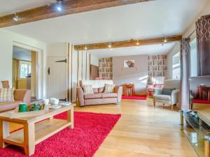 a living room with a couch and a red rug at 5 Bed in Brecon oc-90660 in Lower Chapel +40 photos
