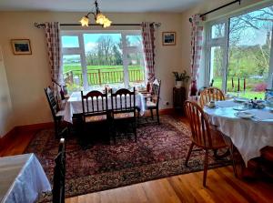 a dining room with a table and chairs and a window at Lake Avenue House in Ballyconnell +37 photos