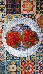 two pizzas on a plate on a table at Dreaming Polignano in San Vito +47 photos