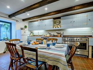 a kitchen with a table and chairs and a kitchen withuclear at 3 Bed in Abergavenny oc-93362 in Capel-y-ffin +25 photos