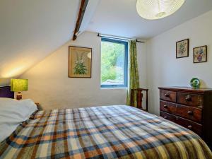 a bedroom with a bed and a window and a dresser at 3 Bed in Abergavenny oc-93362 in Capel-y-ffin