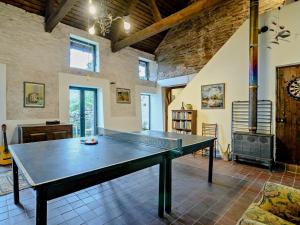 a ping pong table in a room with a fireplace at 3 Bed in Abergavenny oc-93362 in Capel-y-ffin