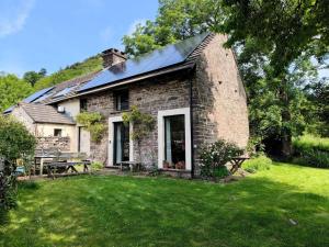 an old brick house with a picnic table in a yard at 3 Bed in Abergavenny oc-93362 in Capel-y-ffin