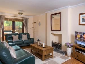 a living room with a couch and a tv at 4 Bed in Ystradgynlais oc-bn343 in Ystalyfera