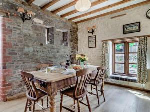 a dining room with a wooden table and chairs at 2 Bed in Brecon oc-bn281 in Llanhamlach +30 photos