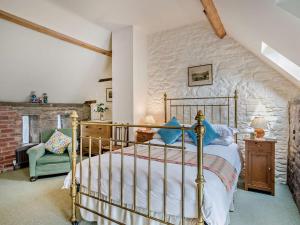 a bedroom with a bed and a stone wall at 2 Bed in Brecon oc-bn281 in Llanhamlach