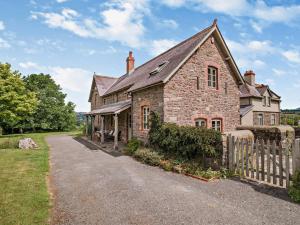 an old brick house with a fence next to a road at 2 Bed in Brecon oc-bn281 in Llanhamlach