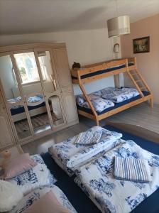 a room with two bunk beds and a mirror at Chata košaríska in Oščadnica