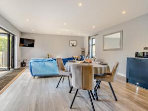a dining room with a table and chairs and a couch at 2 Bed in Knighton oc-94203 in Knighton
