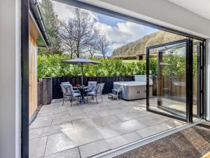 a patio with a tub and a table and chairs at 2 Bed in Knighton oc-94203 in Knighton