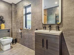 a bathroom with a toilet and a sink and a mirror at 2 Bed in Knighton oc-94203 in Knighton +19 photos