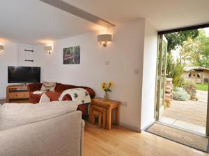 a living room with a couch and a television at 3 Bed in North Tawton oc-66043 in Winkleigh