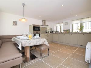 a kitchen with a table and a couch in it at 3 Bed in North Tawton oc-66043 in Winkleigh